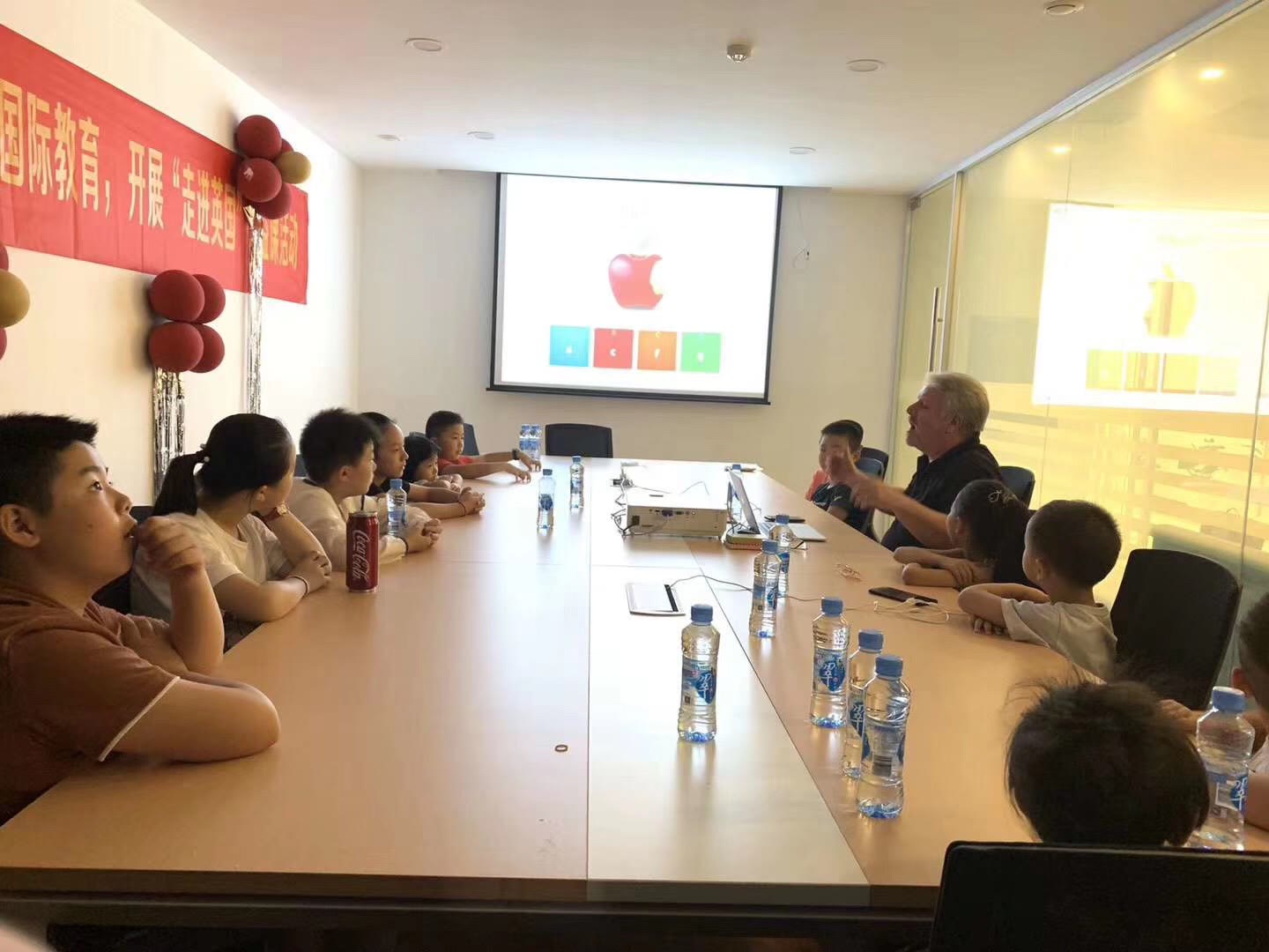 Iain Davie teaching around a shared table in China